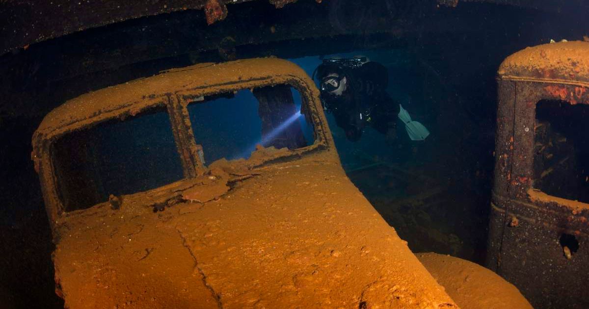 A diver captured exploring a car underwater. (Representative Cover Image Source: Getty Images | apsimo1)