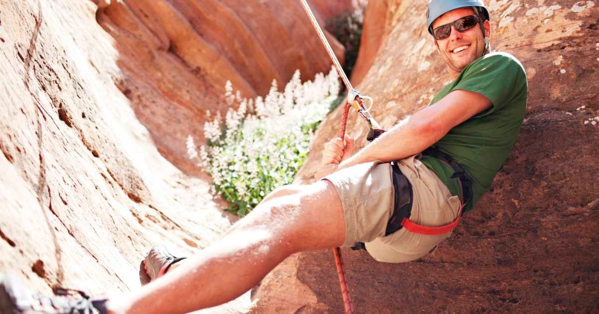 Hiker rappelling in a canyon of Zion National Park (Representative Cover Image Source: Getty Images | Cavan Images)
