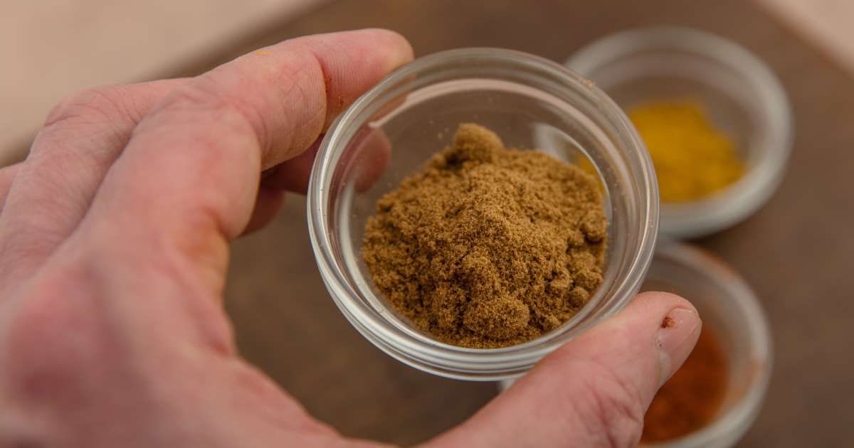 A person holding a cup of ground ginger. (Representative Cover Image Source: Getty Images | Annick Vanderschelden Photography)