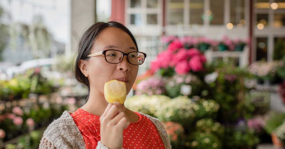 A woman is enjoying an ice cream bar. (Representative Cover Image Source: Getty Images | Morten Falch Sortland)