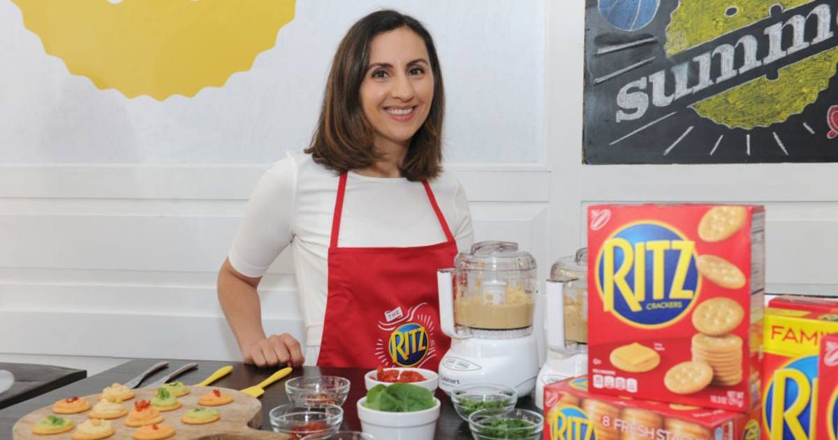 Woman standing in the kitchen creating new recipes using Ritz Crackers. (Representative Cover Image Source: Getty Images | Craig Barritt)