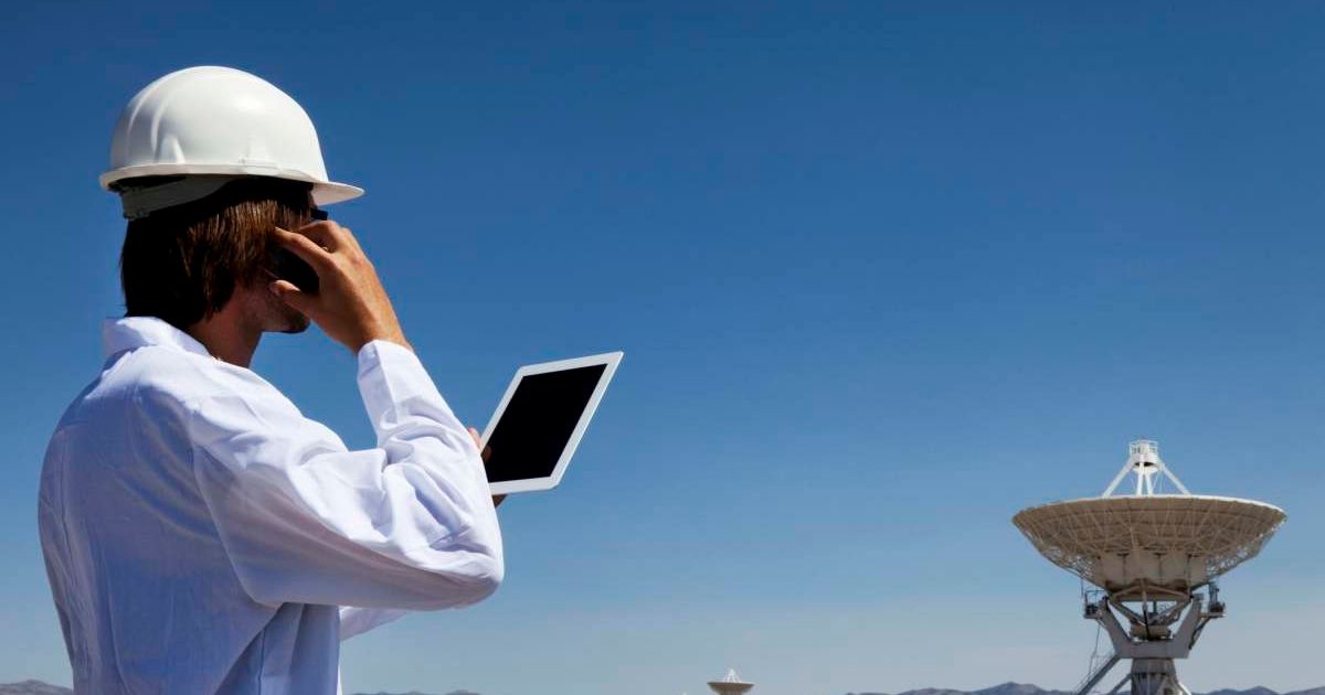 A scientist near a radio telescope. (Representative Cover Image Source: Getty Images | Powerofforever)
