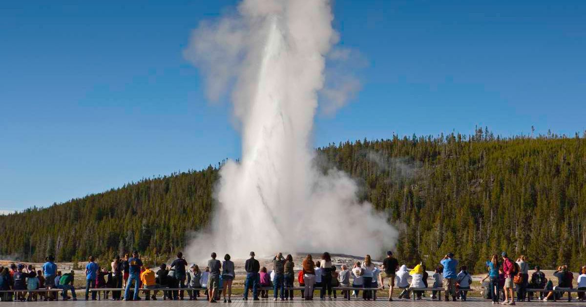 Tourists gather to watch a geyser eruption at Yellowstone National Park. (Representative Cover Image Source: Getty Images | Danny Lehman)
