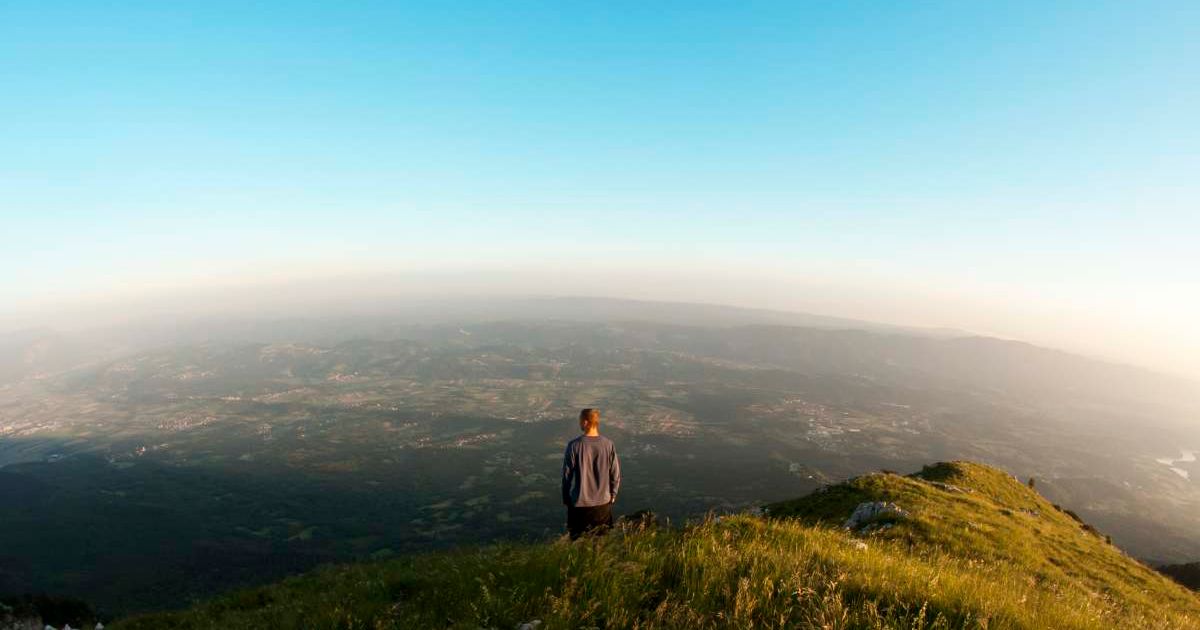 A man looking at the valley from the top of a hill. (Representative Cover Image Source: Getty Images | kmatija)