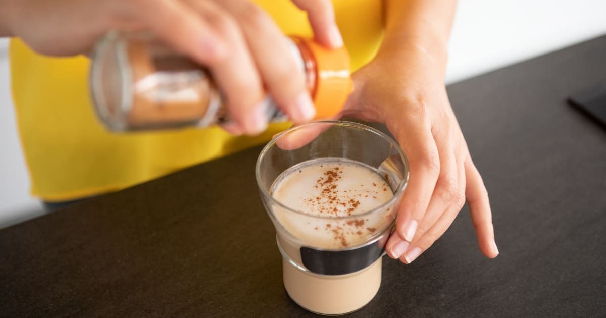 Close-up of woman's hands sprinkling coffee with cinnamon (Representative Cover Image Source: Pexels | Gonçalo Barriga)