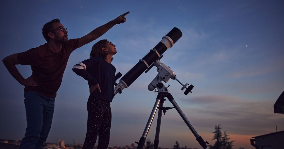 Two people watching the starry skies with telescopes mounted on the ground. (Representative Cover Image Source: Getty Images | M Gucci)