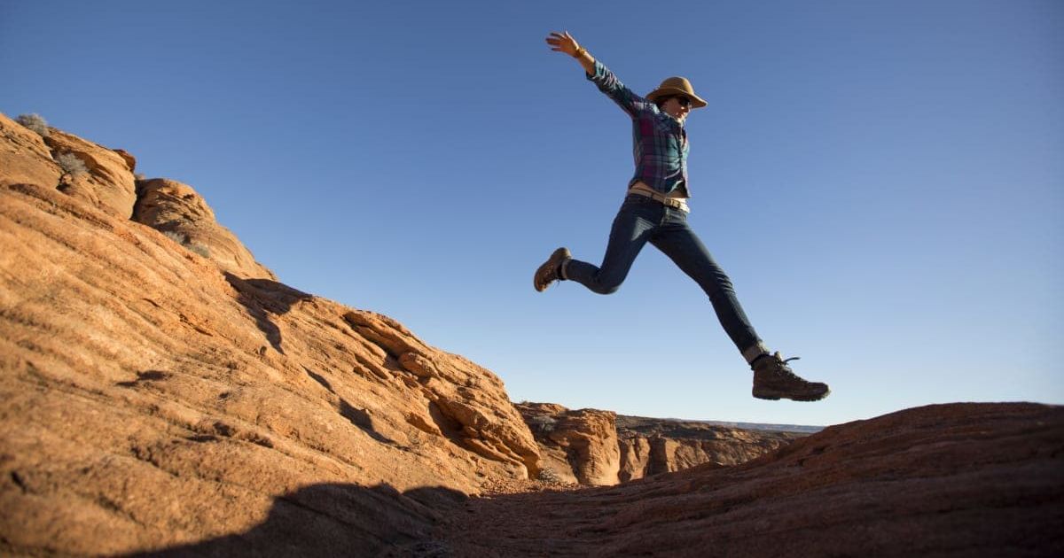 Man jumping over a canyon stretch with excitement in Grand Canyon National Park (Representative Cover Image Source: Getty Images | Jordan Siemens)